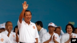 Cambodian Prime Minister Hun Sen waves to supporters during his Cambodian People's Party's campaign in Phnom Penh, Cambodia, Saturday, July 7, 2018. The official campaigning period for July 29 general election began with Hun Sen's ruling party virtually a