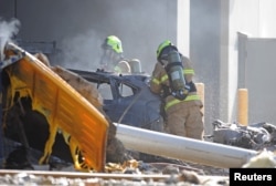 Emergency services personnel are seen at the scene of a plane crash in Essendon near Melbourne, Australia, Feb. 21, 2017.