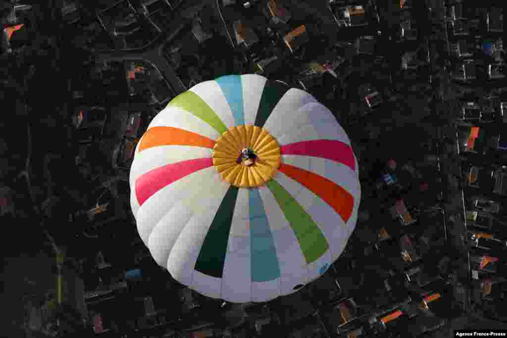 French balloonist Remi Ouvrard attempts to set a world record by standing on the top of a hot air balloon at an altitude of more than 3,637 meters in Chatellerault,&nbsp; France.