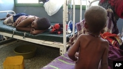 A malnourished child from southern Somalia sits on the bed at Banadir hospital in Mogadishu, Somalia, August 2, 2011