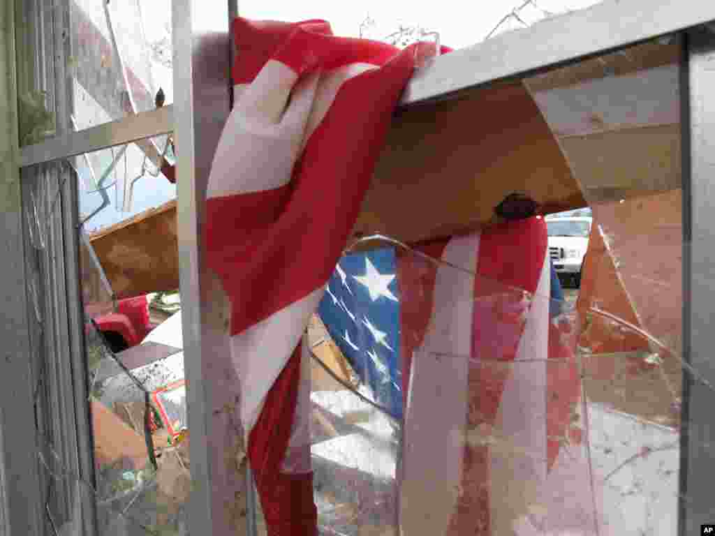 A soggy American flag hangs in a broken window at Wayne Osmus&#39; home in Moore, Oklahoma. Osmus&#39; family hid in a closet Monday after winds kept them from taking refuge in the storm shelter. 