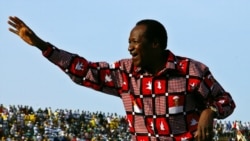 FILE - Burkina Faso President Blaise Compaore waves to supporters at the end of his re-election campaign in Ouagadougou, Nov. 11, 2005.