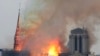 FILE - Flames rise from Notre Dame cathedral as it burns in Paris, Apr. 15, 2019.