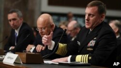 U.S. Cyber Command Commander, National Security Agency Director, Central Security Services Chief Adm. Michael Rogers, right, with Director of National Intelligence James Clapper, center, and Defense Undersecretary for Intelligence Marcel Lettre II, testifies on Capitol Hill in Washington, Jan. 5, 2017.