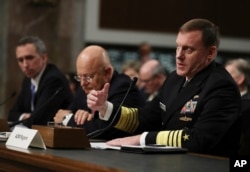 National Security Agency chief Mike Rogers, right, with Director of National Intelligence James Clapper, center, and Defense Undersecretary for Intelligence Marcel Lettre II, testifies on Capitol Hill in Washington before the Senate Armed Services Committee, Jan. 5, 2017.