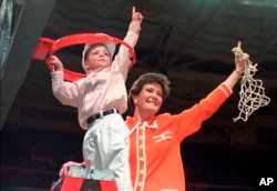 FILE - Tennessee coach Pat Summitt and son, Tyler, take down the net after Tennessee defeated Georgia, 83-65, in the title game at the NCAA women's basketball Final Four at Charlotte Coliseum in Charlotte, North Carolina, March 31, 1996