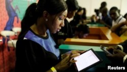 FILE - Youths are seen browsing the internet inside the venue of the launch of Google free wifi project in Lagos, Nigeria, July 26, 2018.