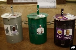 Three ballot drums are set in a polling station in Serrekunda, Gambia, Wednesday Nov. 30, 2016. Voters will choose their candidate by placing a marble inside the drum of their choice.