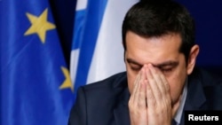 Greece's Prime Minister Alexis Tsipras addresses a news conference after an European Union leaders summit in Brussels, February 12, 2015.