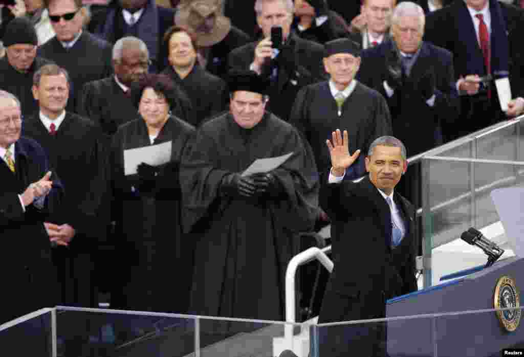 U.S. President Barack Obama waves during ceremonial swearing-in ceremonies on the West front of the U.S Capitol in Washington, January 21, 2013