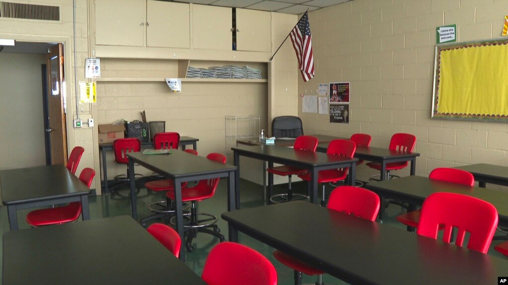 In this image made from video, an empty classroom is shown at David Ellis Academy in Detroit, Monday, Feb. 8, 2021. (AP Photo/Mike Householder File) 