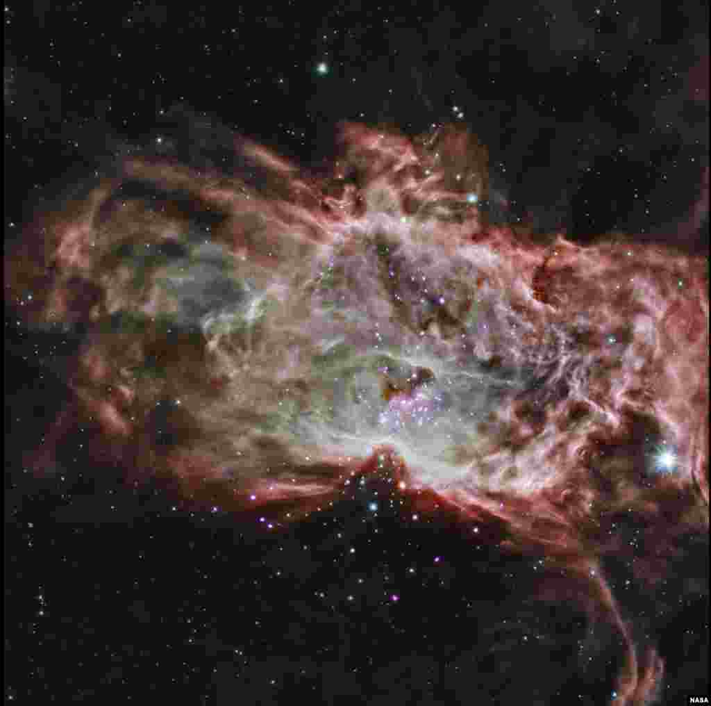 This composite image shows one of the clusters, NGC 2024, which is found in the center of the so-called Flame Nebula about 1,400 light years from Earth. In this image, X-rays from Chandra are seen as purple, while infrared data from NASA's Spitzer Space Telescope are colored red, green, and blue. Astronomers have studied two star clusters and the results show that the simplest ideas for the birth of these clusters cannot work.