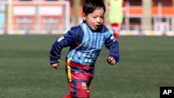 Murtaza Ahmadi, a five-year-old Afghan Lionel Messi fan, plays football at the Afghan Football Federation Stadium in Kabul, Afghanistan, Tuesday, Feb. 2, 2016.