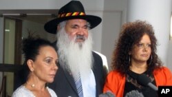 FILE - Australian indigenous opposition lawmakers Linda Burney, left, Pat Dodson, center, and Malarndirri McCarthy speak to reporters in Parliament House in Canberra, Australia, Feb. 8, 2018, after a report finds the life expectancy gap between Aboriginal and non-indigenous people is widening. 