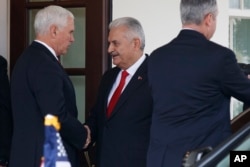 FILE - Vice President Mike Pence shakes hands with Turkish Prime Minister Binali Yildirim after a meeting at the White House, Nov. 9, 2017, in Washington.