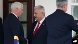 Vice President Mike Pence, left, shakes hands with Turkish Prime Minister Binali Yildirim after a meeting at the White House, Nov. 9, 2017, in Washington.