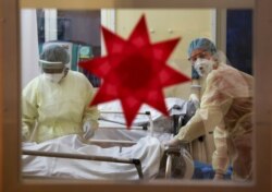 Dekorasi Natal digambarkan di jendela saat anggota staf medis dengan pakaian pelindung merawat pasien yang menderita penyakit virus corona (COVID-19) di Unit Perawatan Intensif (ICU) di Rumah Sakit Komunitas Havelhoehe di Berlin. (Foto: Reuters)