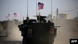 A convoy of U.S. forces armored vehicles drives near the village of Yalanli, on the western outskirts of the northern Syrian city of Manbij, March 5, 2017.