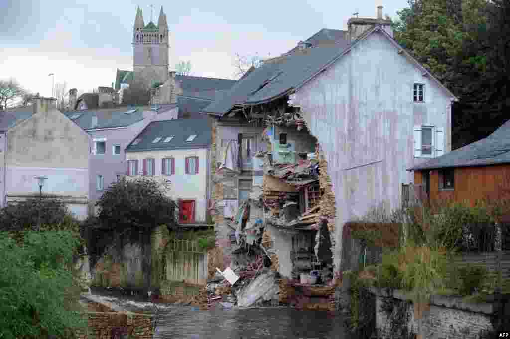 The facade of a house collapses due to floods after the Dirk storm in Quimperle, western of France.