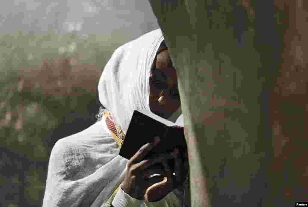 An Ethiopian Orthodox worshipper prays during the washing of the feet ceremony at the Ethiopian section of the Church of the Holy Sepulchre in Jerusalem&#39;s Old City.