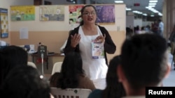 FILE - Patients participate in a Zika prevention talk as they wait to be attended to at the Women's National Hospital in San Salvador, El Salvador, Jan. 29, 2016. 