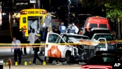 FILE - Authorities stand near a damaged Home Depot truck after a motorist drove onto a bike path near the World Trade Center memorial, striking and killing several people in New York, Oct. 31, 2017.