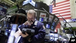 You can often tell from their faces if traders working the floor of the New York Stock Exchange are in the black or in the red. (AP Photo/Richard Drew, 2010)