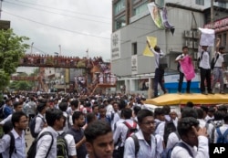 Bangladeshi students shout slogans as they block a road during a protest in Dhaka, Bangladesh, Aug. 1, 2018.