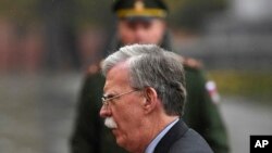 U.S. National Security Adviser John Bolton attends a wreath laying ceremony at the Tomb of the Unknown Soldier by the Kremlin wall in Moscow, Russia, Tuesday, Oct. 23, 2018. U.S. President Donald Trump's national security adviser Bolton struck a conciliatory note Tuesday in talks in Moscow, just days after Trump vowed to pull out of a key arms control treaty with Russia. (Kirill Kudryavtsev/Pool Photo via AP)