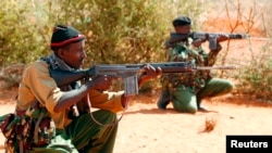 FILE - Kenyan policemen hold their position while patrolling the Kenya-Somalia border near the town of Mandera. A string of attacks earlier this month have raised safety concerns about in the Mandera region.