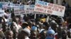 People originally from northern Mali carry signs reading 'We support army action to liberate the North,' as thousands of Malians, including elected officials, front, marched in support of foreign aid and military intervention to retake Mali's north from I