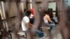 Part of a group of fourteen suspected members of a ring of human traffickers are kept in a holding cell in court in Guatemala City, August 9, 2012.