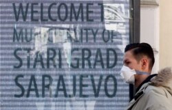 A man wearing a face mask walks in Sarajevo, April 2020