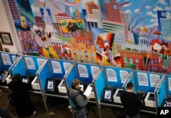 FILE - Voters cast their ballots at the Denver Elections Division, in Denver, Colorado, Nov. 6, 2018.