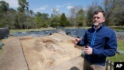 Historic Jamestown senior staff archaeologist David Givens gestures at the dig site of the Angelo slave house in Jamestown, Va., April 10, 2018.