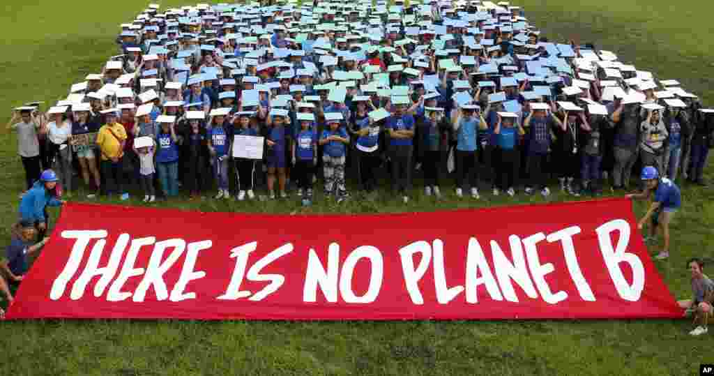 Environmental activists, mostly students, display their message in front of &quot;a human globe&quot; formation to coincide with the global protests on climate change Friday, Sept. 20, 2019, at the University of Philippines campus in suburban Quezon city northeast of Manila, Philippines.&nbsp;(AP Photo/Bullit Marquez)
