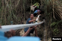 People collect mountain spring water, after Hurricane Maria hit the island, in Corozal, Puerto Rico, Oct. 17, 2017.