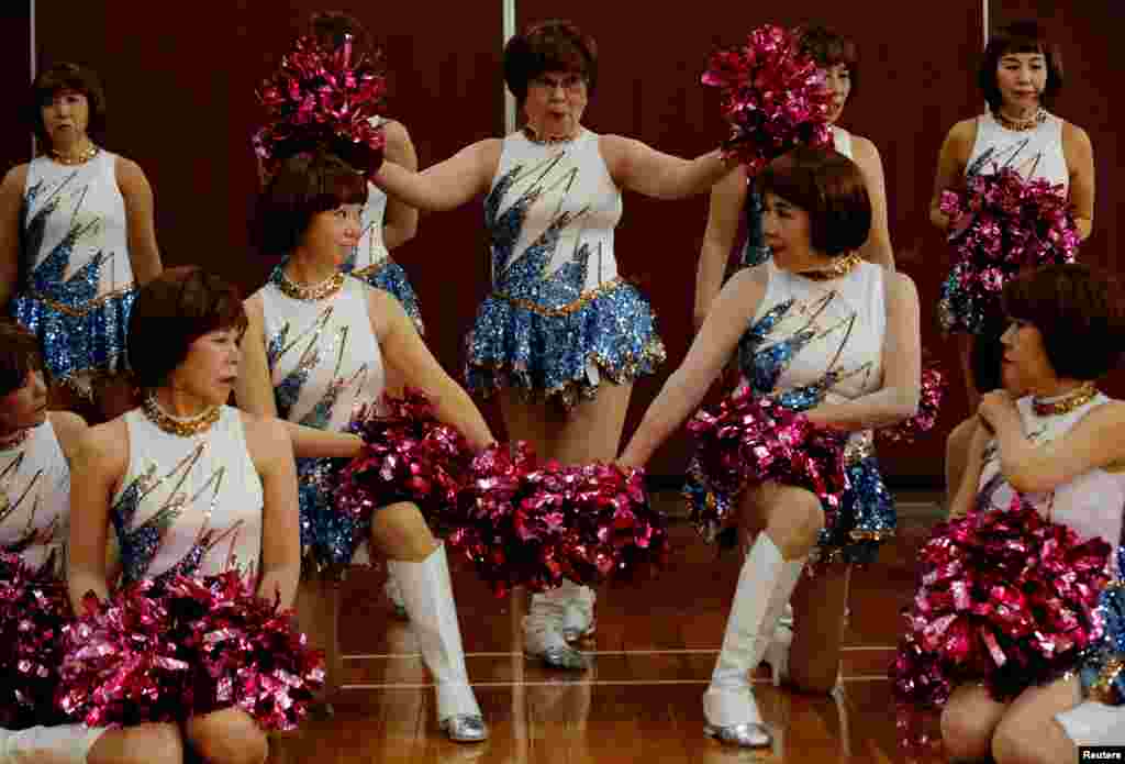 Fumie Takino, 89, founder of a senior cheer squad called Japan Pom Pom, and other members pose for commemorative photos before filming a dance routine for an online performance in Tokyo, Japan.