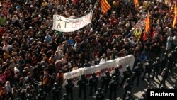 Catalan separatist protesters stand in front of Mossos d'Esquadra police officers in Barcelona, Spain, Sept. 29, 2018, before clashing during a protest against a demonstration in support of the Spanish police units who took part in the operation to prevent the independence referendum in Catalonia on Oct. 1, 2017. 