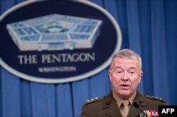 FILE - Lieutenant General Kenneth McKenzie briefs the press at the Pentagon in Washington, April 14, 2018.