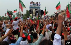 FILE - Supporters of the Pakistani Tehreek-e-Insaf party cheer their leader, Imran Khan, prior to the start of an anti-government rally in Peshawar, Pakistan, Aug. 7, 2016. Khan's party has been leading the legal battles against Prime Minister Nawaz Sharif.