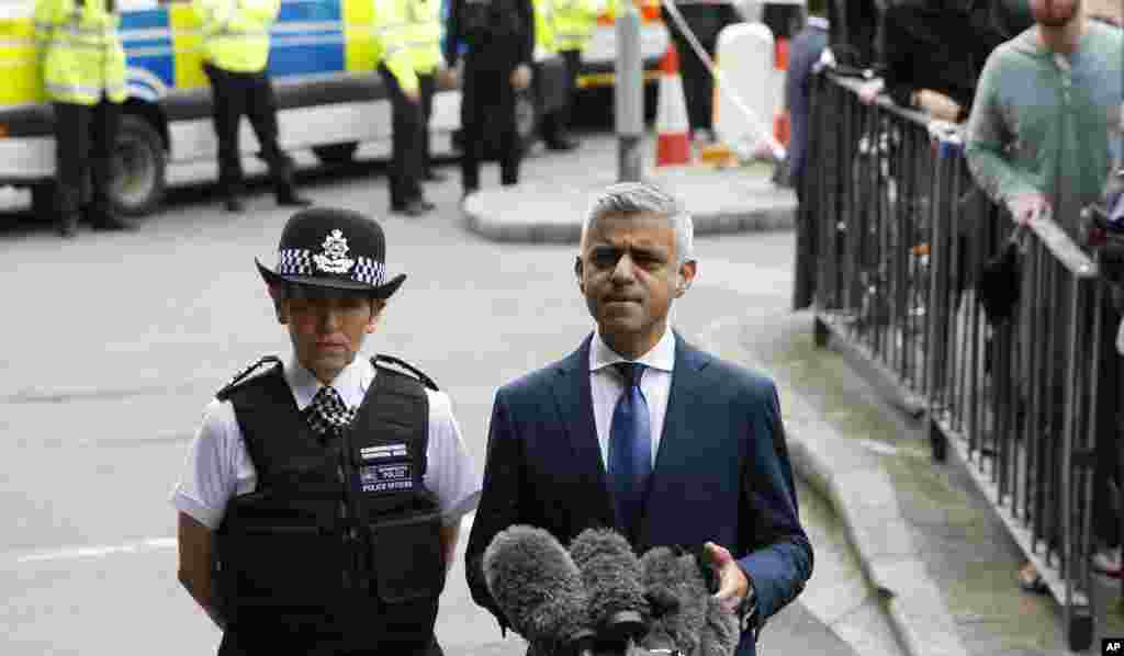 Mayor of London Sadiq Khan, right, speaks during a media conference at London Bridge, June 5, 2017. Police arrested several people and are widening their investigation after a series of attacks in the heart of London on Saturday.