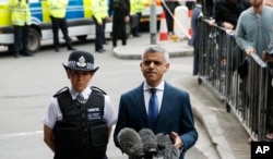 Mayor of London Sadiq Khan, right, speaks during a media conference at London Bridge in London, June 5, 2017.