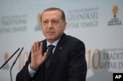In this June 6, 2017, photo, Turkey's President Recep Tayyip Erdogan addresses foreign ambassadors at a Ramadan dinner in Ankara, Turkey. Erdogan has voiced support for Qatar in its dispute with Saudi Arabia and other nations.