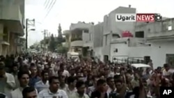 An image taken from footage uploaded on YouTube shows Syrian anti-government protesters flooding the streets of the central city of Hama, July 8, 2011