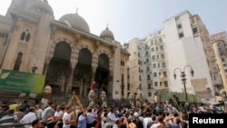 Anti-Morsi protesters and riot police officers gather outside al-Fath mosque at Ramses Square in Cairo, August 17, 2013. 