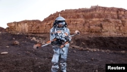 A scientist holds a drone as he participates in a demonstration of an experiment led by Austrian and Israeli agencies simulating a mission to Mars near Mitzpe Ramon, Israel, Oct. 10, 2021.