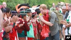 A handout photo provided by National News Agency of Nepal, shows Britain’s Prince Harry as he is welcomed by villagers upon his arrival in Lamjung, Nepal, March 21, 2016.