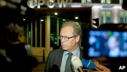 Spokesman Michael Luhan gives a brief statement outside the headquarters of the Organization for the Prohibition of Chemical Weapons, OPCW, in The Hague, Netherlands, Sept. 27, 2013. 