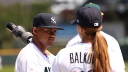 FILE - Rachel Balkovec coaches Jasson Dominguez during American League batting practice of the MLB All Star Futures game, July 11, 2021, in Denver.